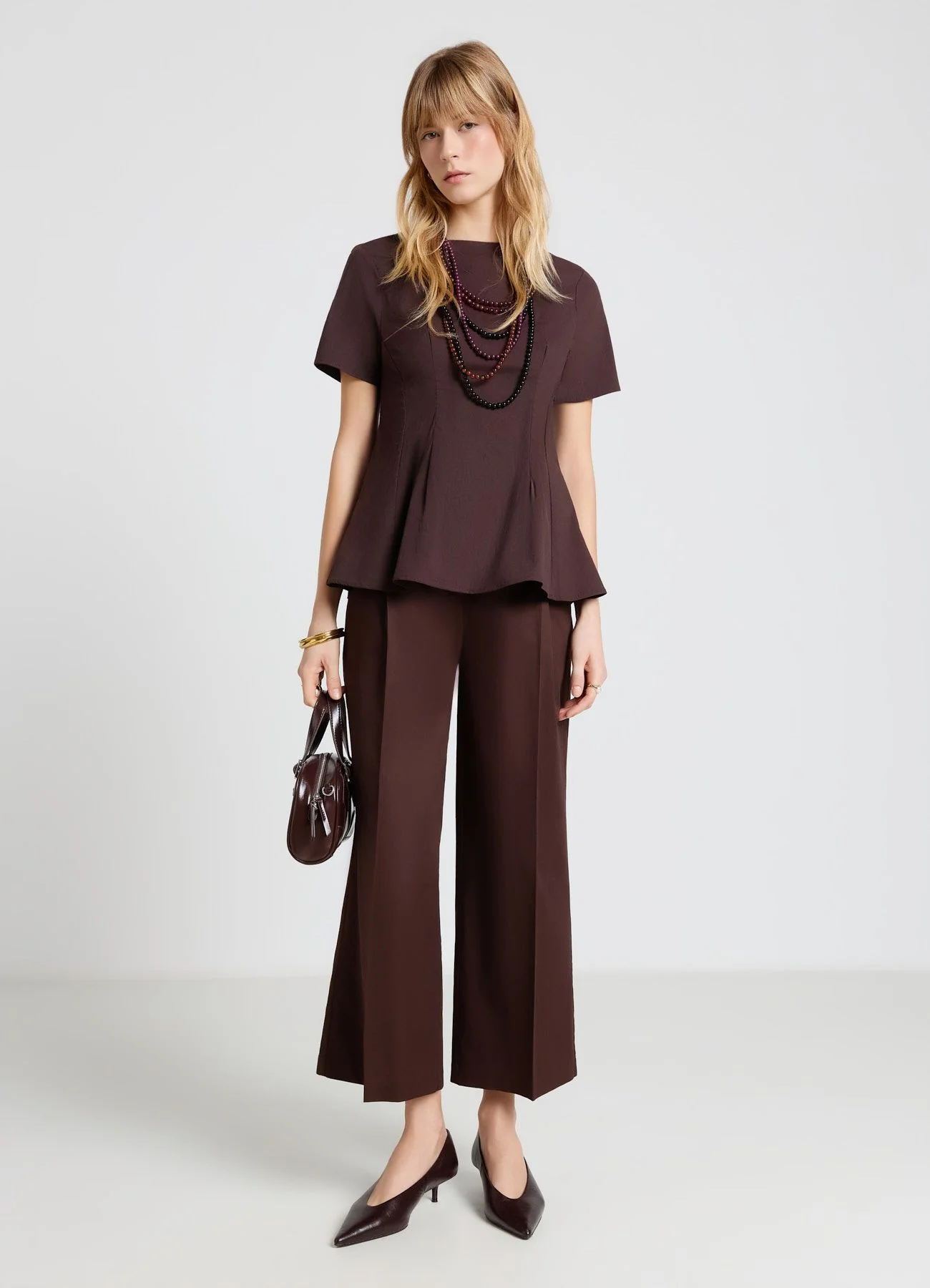 Blusa peplo con zip sul retro
