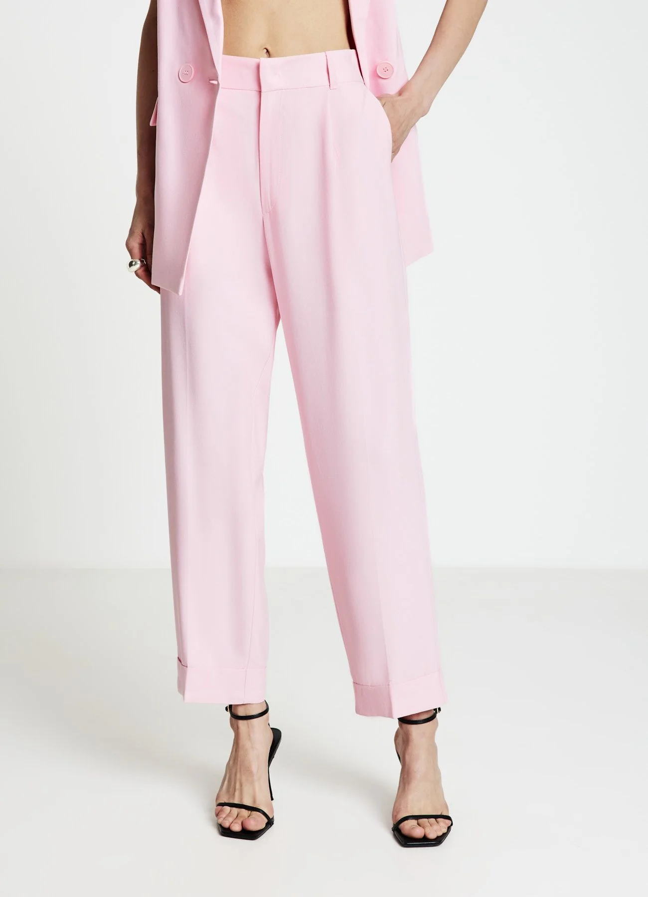 Pantaloni con risvolto tinta unita