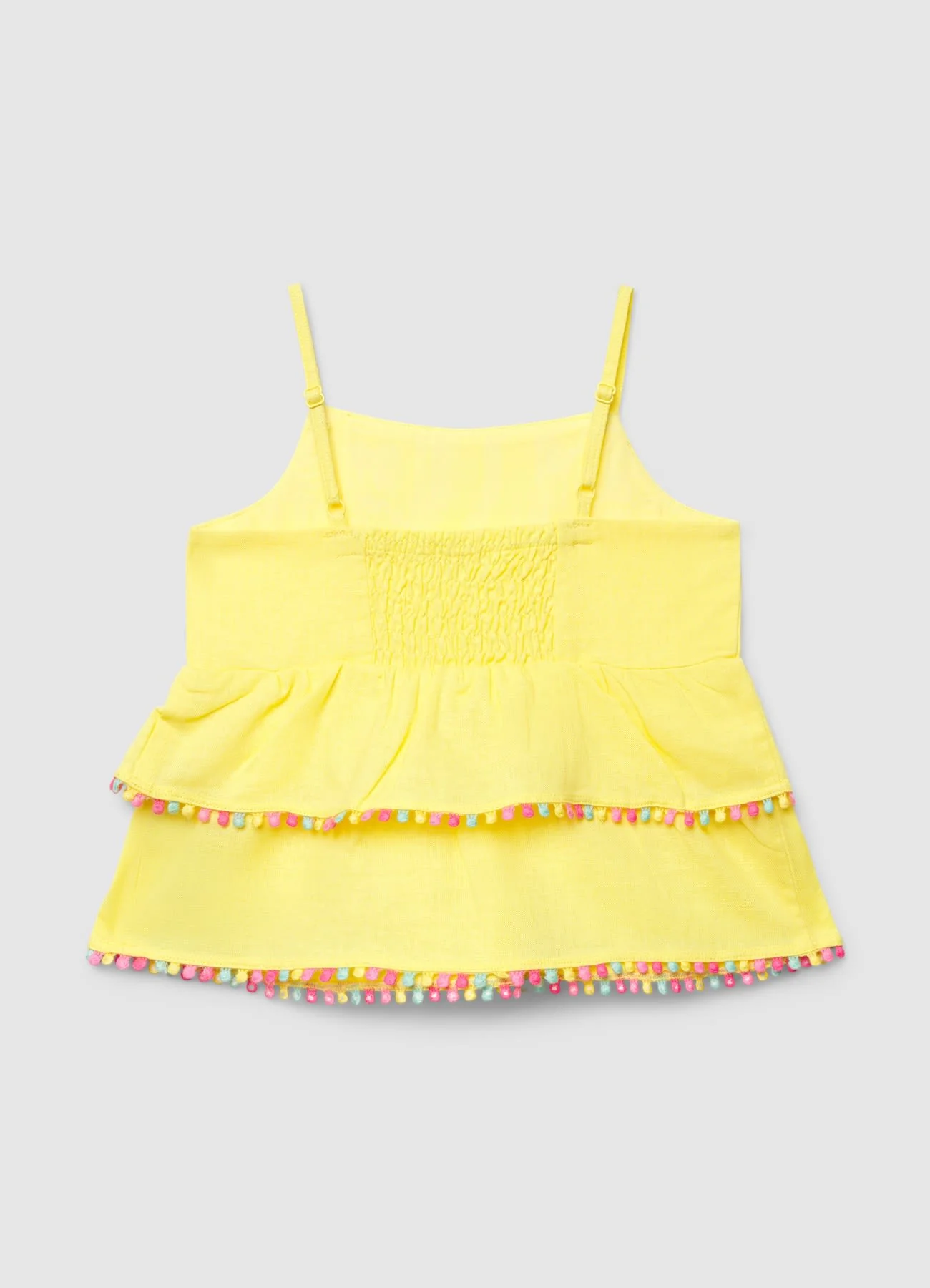 Top con balze e profilo con pompon